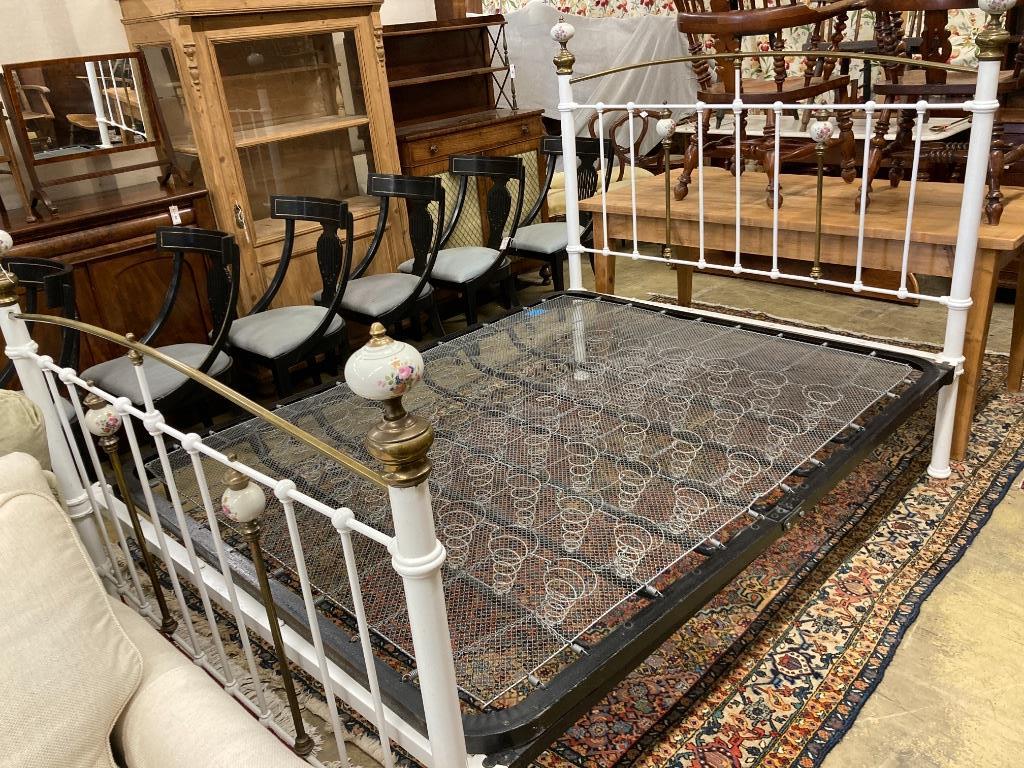 A Victorian style brass and painted iron porcelain mounted bed frame, width 150cm, length 210cm